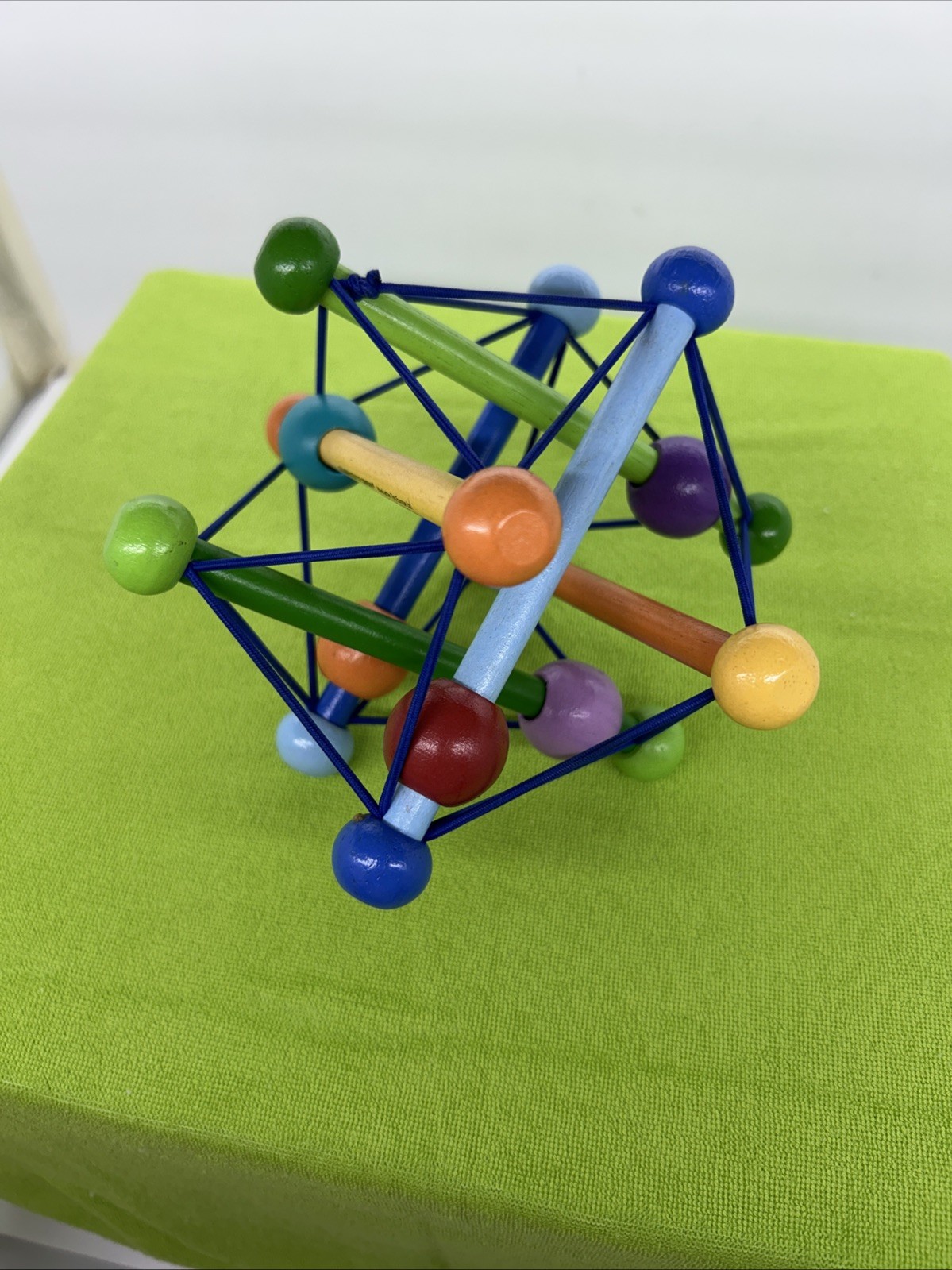 Manhattan Toy Skwish Fidget Wooden Toy Green Red Yellow Rattle