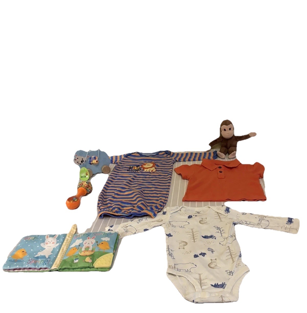 collection of infant clothing and toys, including branded