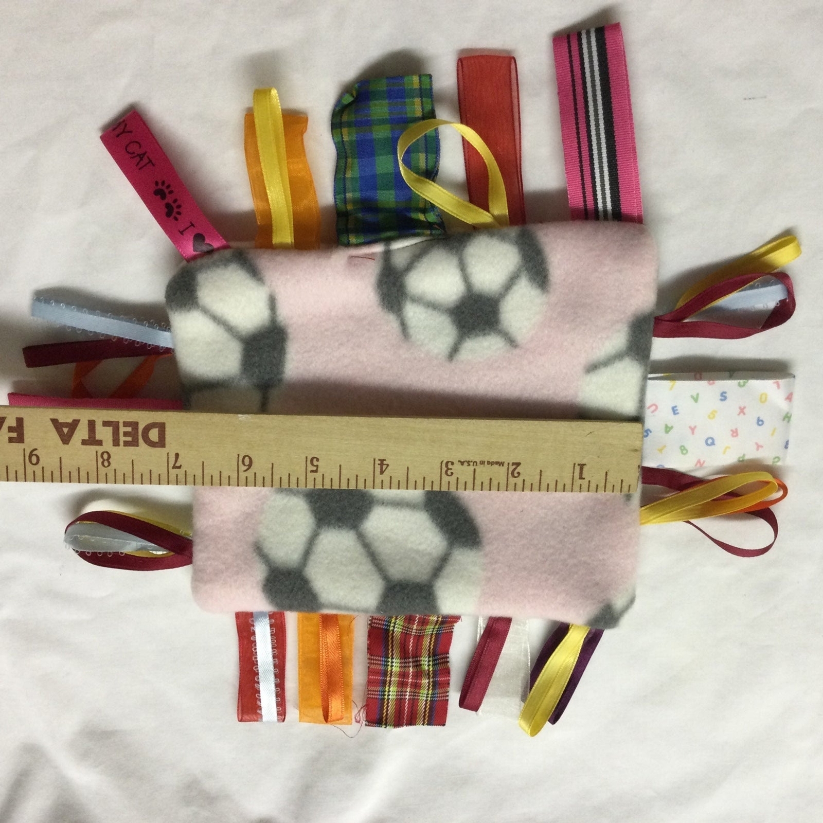 Taggie Baby Toy Soccer theme Handmade New. Sensory Tactile Pink with Soccerballs